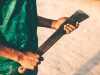 Young african man holding machete.