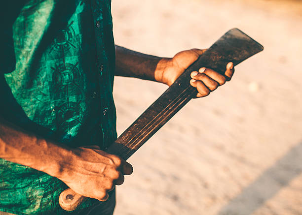 Young african man holding machete.